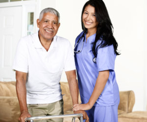 caregiver assisting a patient in walking